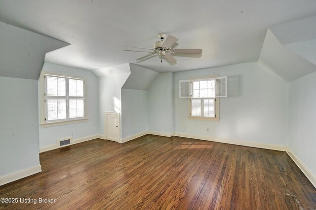 bonus room featuring visible vents, wood finished floors, baseboards, ceiling fan, and vaulted ceiling