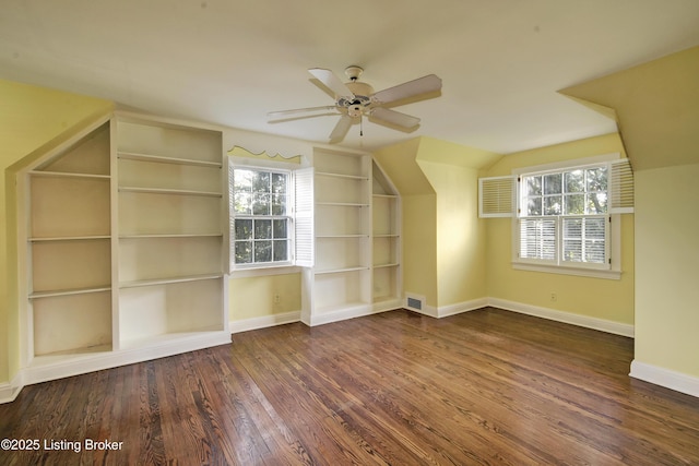 additional living space featuring ceiling fan, baseboards, plenty of natural light, and wood finished floors