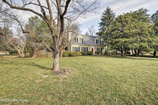 cape cod home with a front lawn