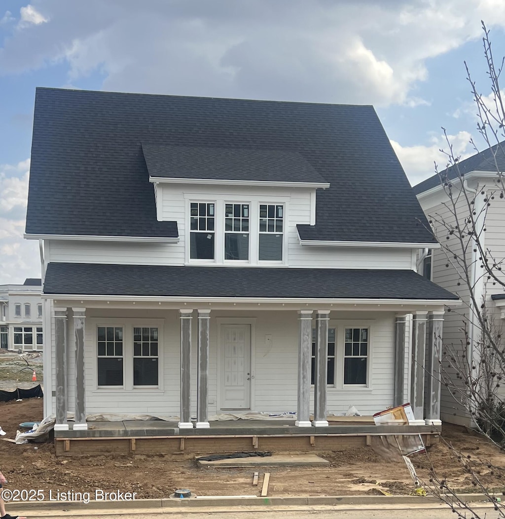 view of front of property featuring a porch and a shingled roof