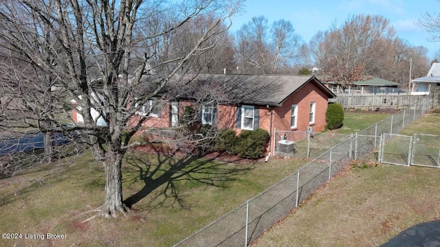 view of front of house featuring brick siding, fence, central air condition unit, a front yard, and a gate