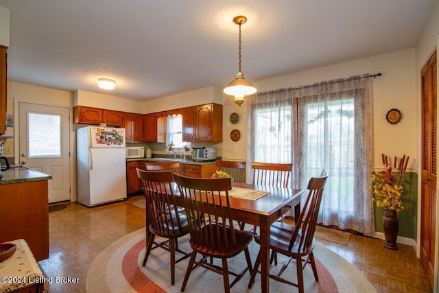 dining room featuring baseboards and a healthy amount of sunlight