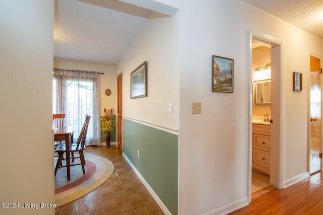 hall with parquet floors and baseboards