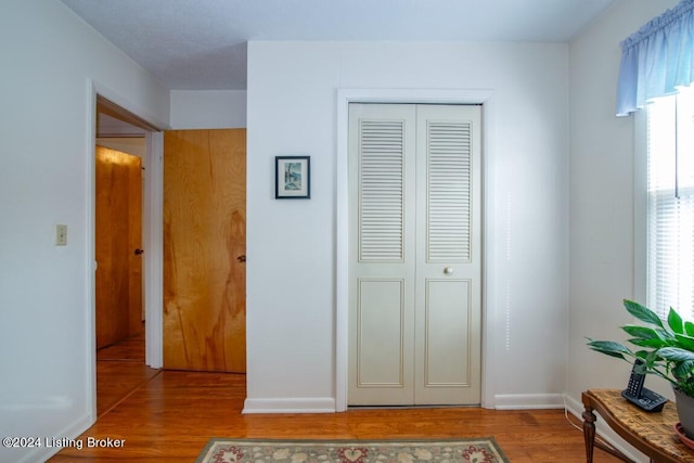 bedroom featuring a closet, baseboards, and wood finished floors