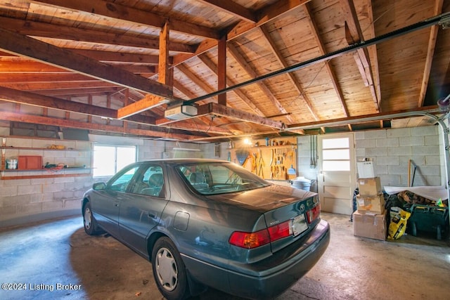 garage with concrete block wall and a garage door opener