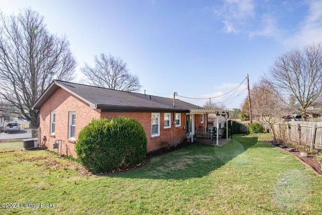 rear view of house with brick siding, central air condition unit, a yard, a fenced backyard, and a pergola