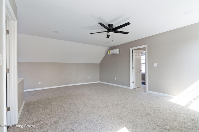 additional living space featuring a ceiling fan, a wall mounted AC, baseboards, carpet flooring, and lofted ceiling