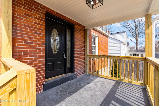 view of exterior entry with brick siding