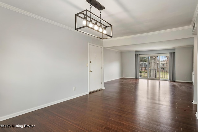 unfurnished room with an inviting chandelier, wood finished floors, baseboards, and ornamental molding