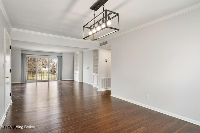 unfurnished room with a chandelier, visible vents, dark wood-type flooring, and ornamental molding