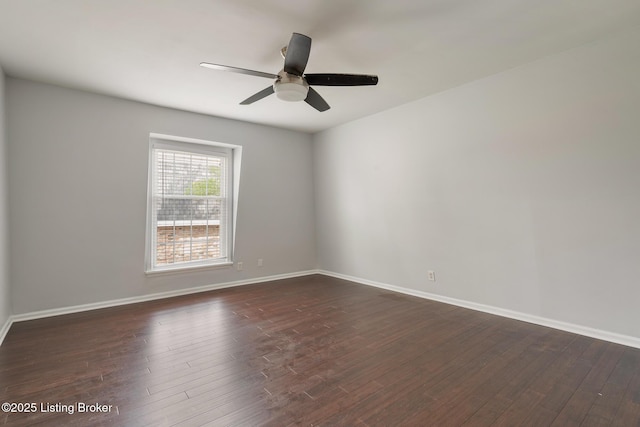 unfurnished room featuring baseboards, dark wood-type flooring, and a ceiling fan