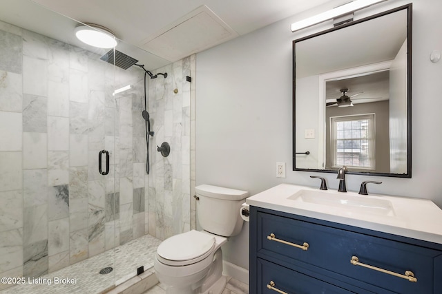 full bathroom featuring vanity, a ceiling fan, a shower stall, and toilet