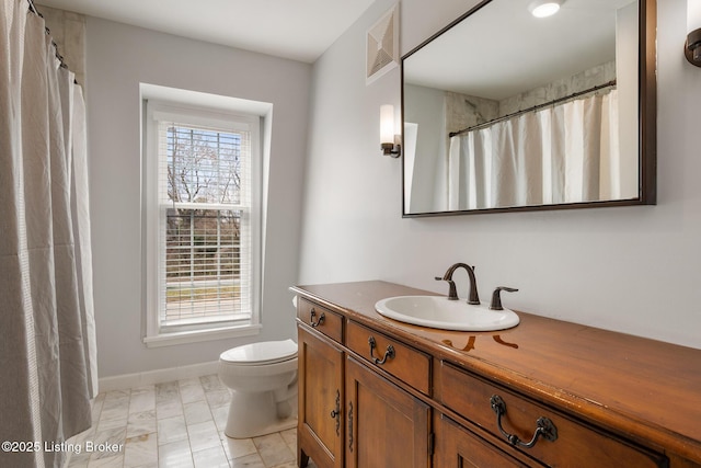 bathroom with a wealth of natural light, visible vents, toilet, and vanity