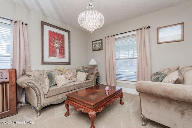 living area featuring a notable chandelier, carpet, a wealth of natural light, and a textured ceiling