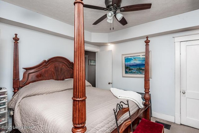 carpeted bedroom with ceiling fan, visible vents, and a textured ceiling