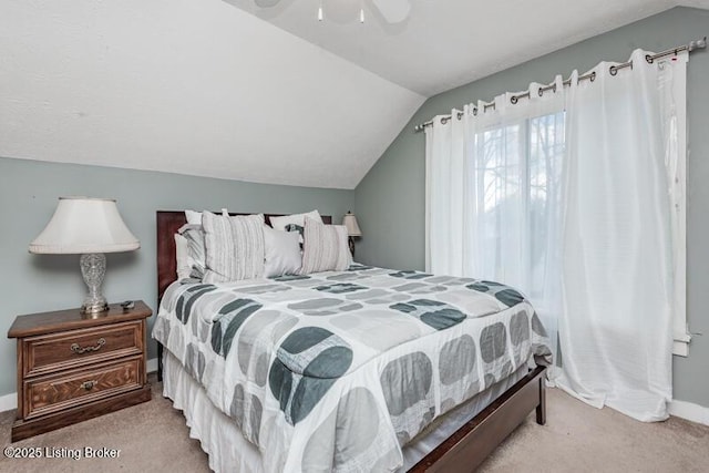 bedroom with vaulted ceiling, a ceiling fan, baseboards, and carpet floors