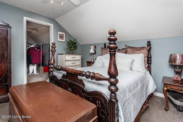 carpeted bedroom featuring a closet, a textured ceiling, ceiling fan, and vaulted ceiling