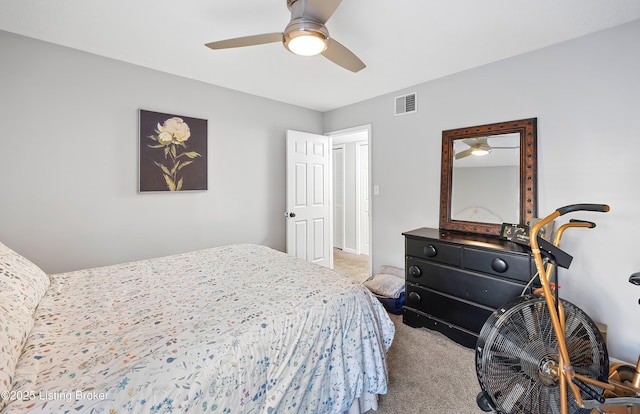 carpeted bedroom featuring a ceiling fan and visible vents