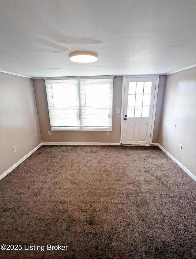 carpeted spare room with baseboards