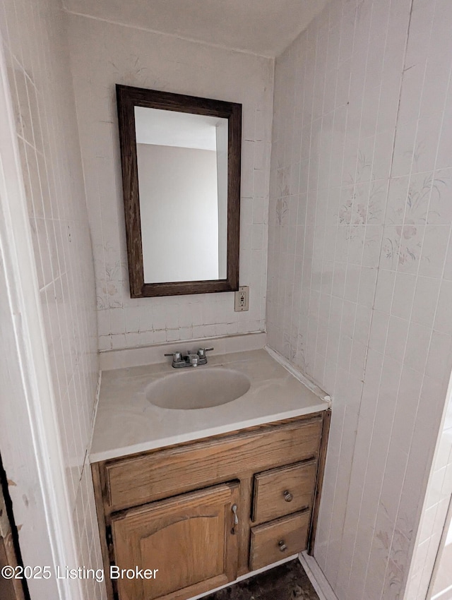 bathroom with tile walls and vanity