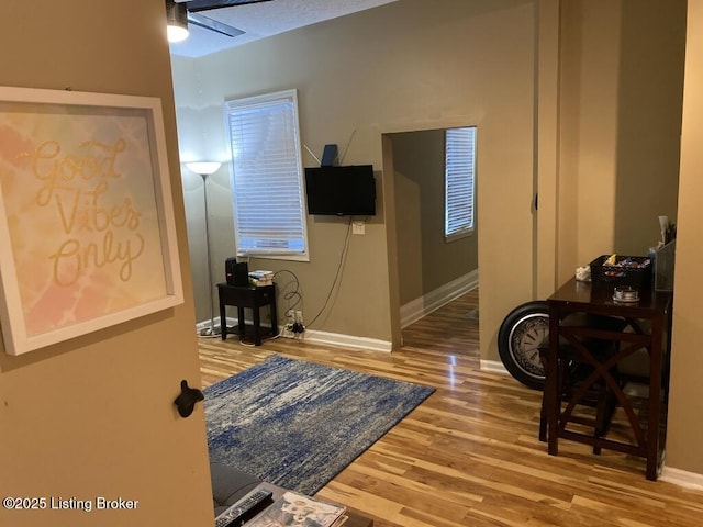 interior space featuring baseboards and wood finished floors