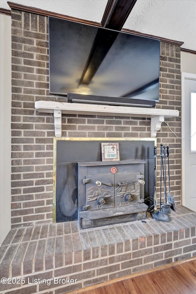 details with wood finished floors and a wood stove