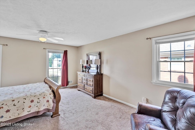 bedroom with visible vents, baseboards, carpet flooring, a textured ceiling, and a ceiling fan