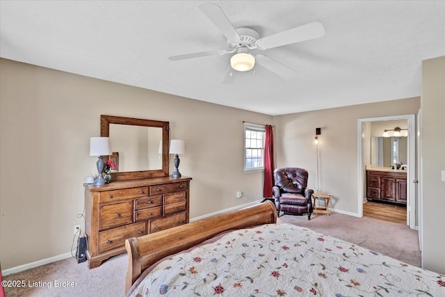 bedroom with ceiling fan, connected bathroom, baseboards, and light carpet