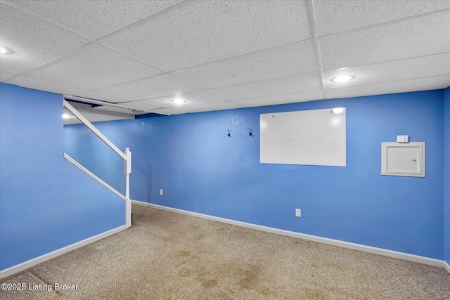 finished basement featuring a drop ceiling, baseboards, carpet floors, and recessed lighting