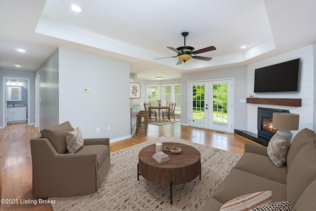 404 Persell Rd, Bedford, KY 40006 - living room featuring a raised ceiling, light wood-style flooring, ceiling fan, and recessed lighting