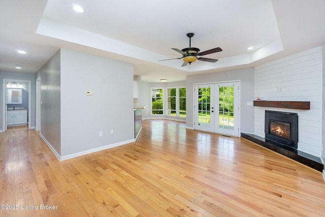 404 Persell Rd, Bedford, KY 40006 - unfurnished living room with a raised ceiling, light wood finished floors, a large fireplace, ceiling fan, and recessed lighting