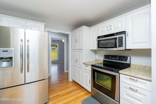 404 Persell Rd, Bedford, KY 40006 - kitchen featuring appliances with stainless steel finishes, light wood-type flooring, white cabinetry, and light stone counters