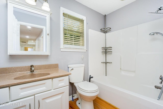 404 Persell Rd, Bedford, KY 40006 - bathroom featuring vanity, toilet, shower / washtub combination, and wood finished floors