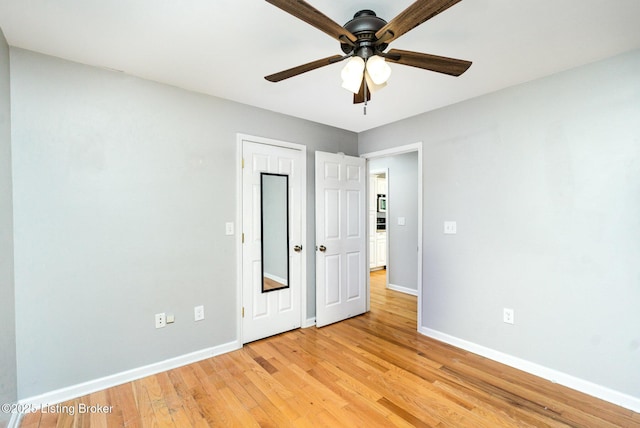 404 Persell Rd, Bedford, KY 40006 - unfurnished bedroom featuring baseboards, light wood-style floors, and a ceiling fan
