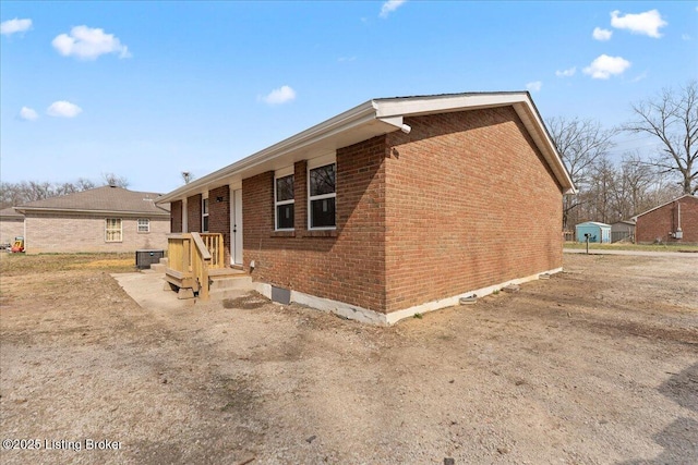 view of side of property featuring brick siding