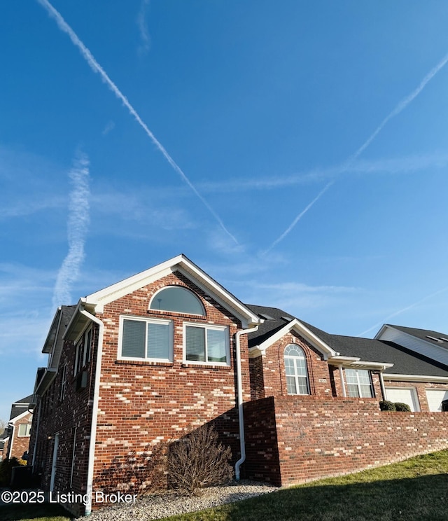 view of side of property featuring brick siding