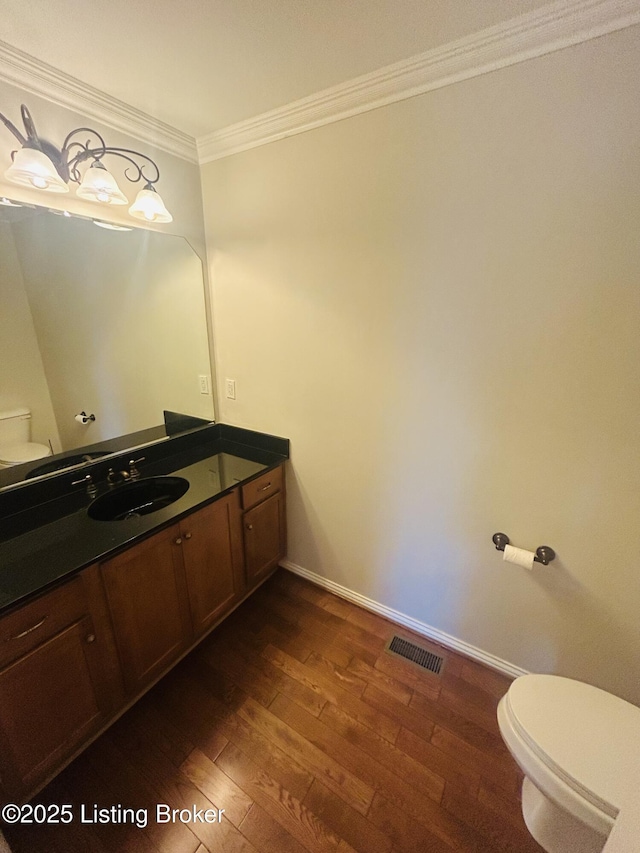 105-A Legacy Ct, Elizabethtown, KY 42701 - bathroom with visible vents, toilet, wood finished floors, crown molding, and vanity