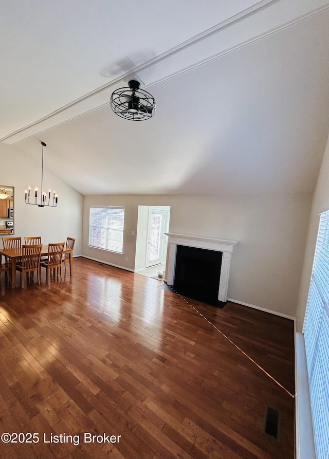 105-A Legacy Ct, Elizabethtown, KY 42701 - unfurnished living room featuring hardwood / wood-style floors, visible vents, lofted ceiling with beams, a fireplace with flush hearth, and ceiling fan with notable chandelier