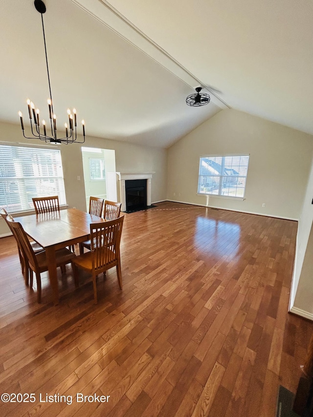 105-A Legacy Ct, Elizabethtown, KY 42701 - dining area featuring lofted ceiling, an inviting chandelier, a fireplace with flush hearth, and wood-type flooring