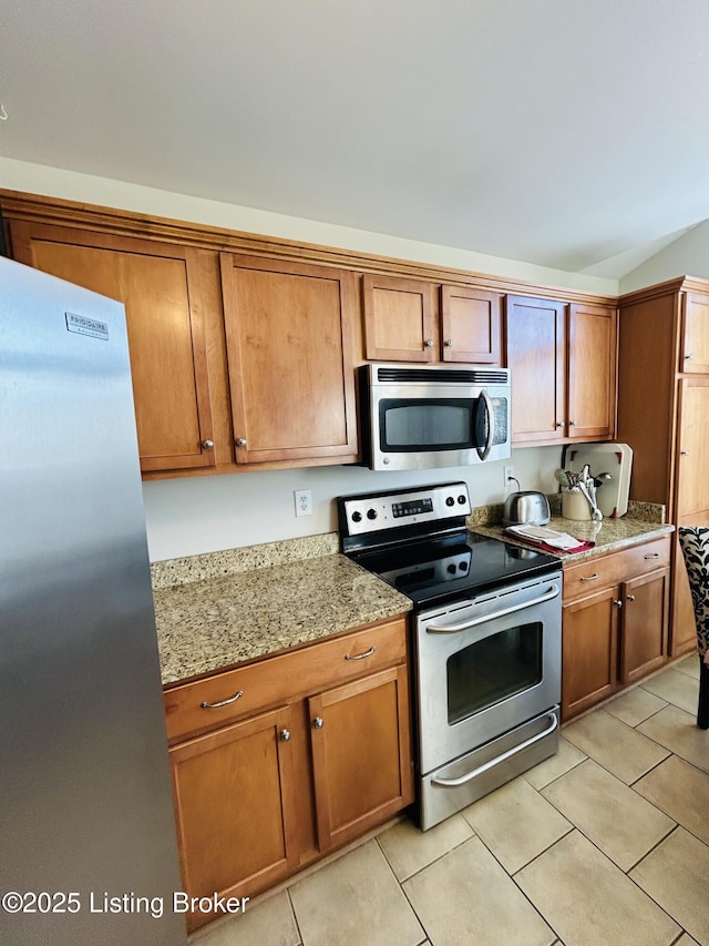 105-A Legacy Ct, Elizabethtown, KY 42701 - kitchen with light tile patterned floors, brown cabinetry, and appliances with stainless steel finishes