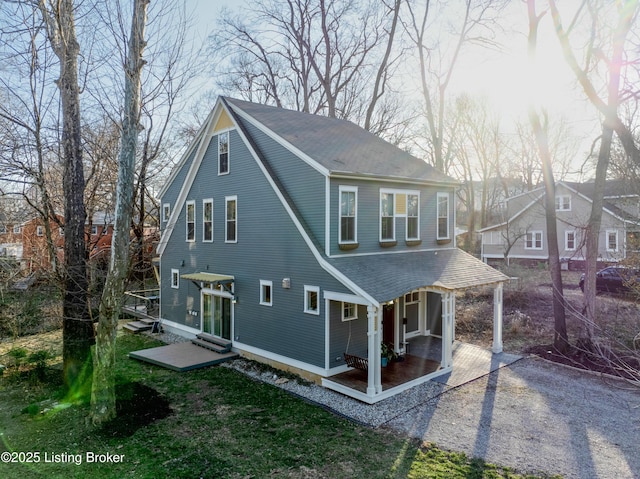 exterior space with driveway, a shingled roof, and entry steps