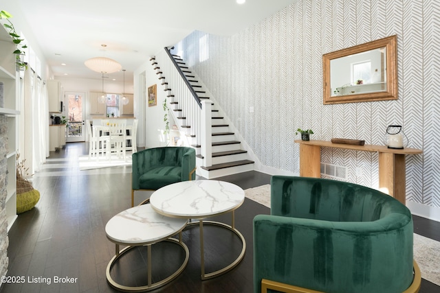 sitting room featuring stairway, wood finished floors, baseboards, wallpapered walls, and recessed lighting