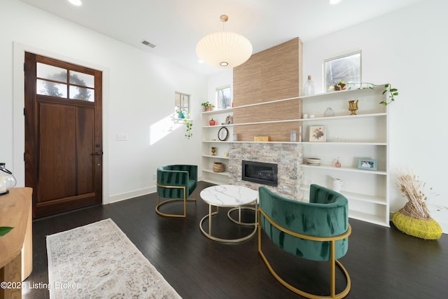 interior space featuring visible vents, recessed lighting, a fireplace, baseboards, and dark wood-style flooring