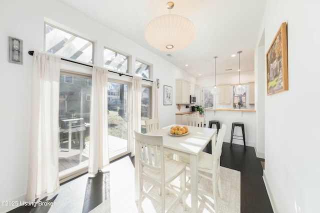 dining space with recessed lighting, baseboards, and dark wood-type flooring