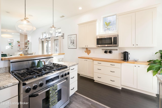 kitchen with visible vents, wooden counters, recessed lighting, stainless steel appliances, and dark wood-style flooring