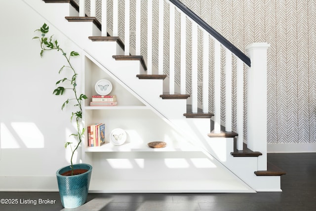 staircase with wood finished floors and baseboards