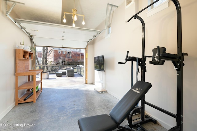 workout room with a garage and baseboards