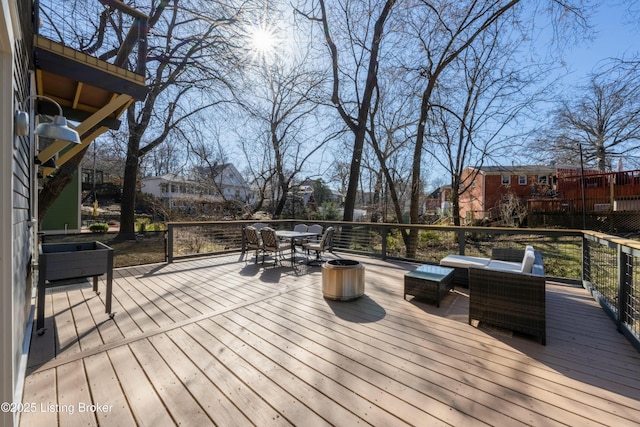 deck featuring an outdoor living space and outdoor dining space