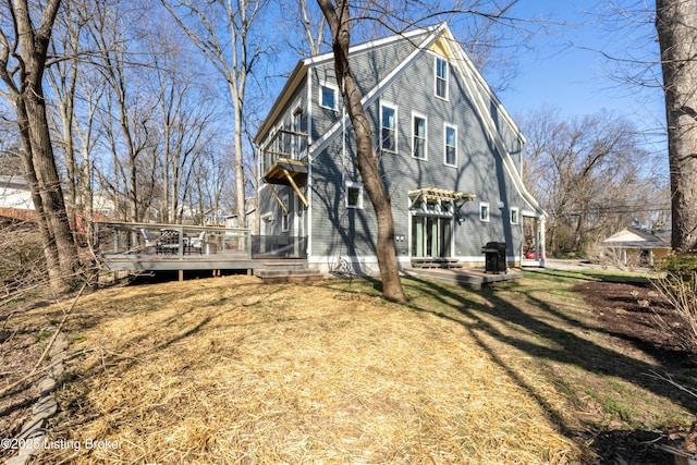 exterior space featuring a patio, a deck, and a front yard