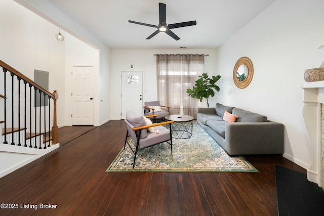 living room with baseboards, stairs, a ceiling fan, and wood-type flooring